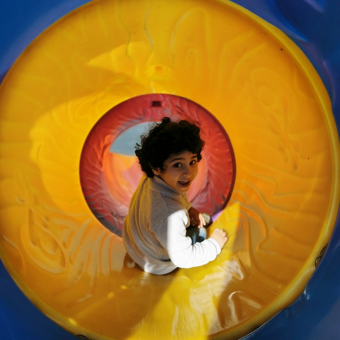 niño jugando en tobogán